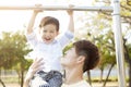 Father with son training on pull-up barÃÂ 